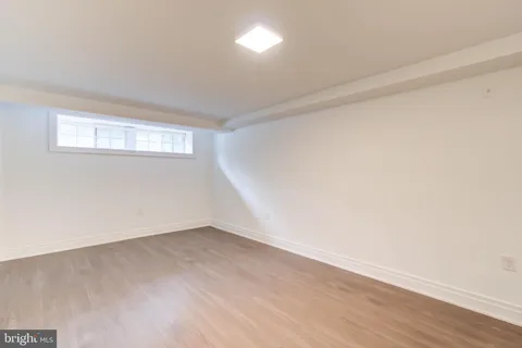 a large white kitchen with a white stove top oven and white cabinets