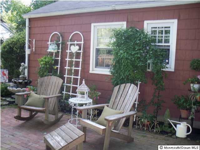 203 Garden Road Shrewsbury, NJ 07702 - Photo 2 of 3 a front view of a house with a garden
