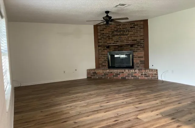 a living room with fireplace furniture and a wooden floor