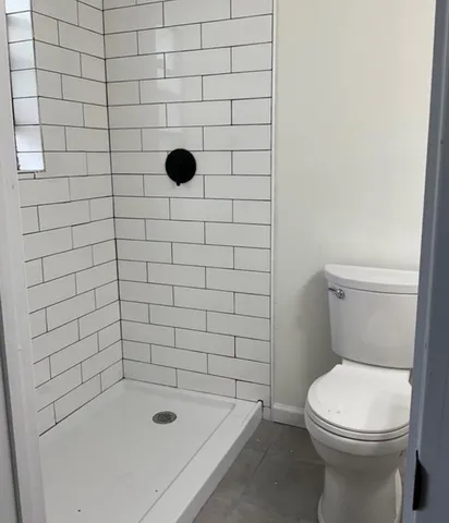 a bathroom with a bathtub and a toilet