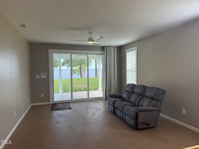 a living room with furniture and a floor to ceiling window