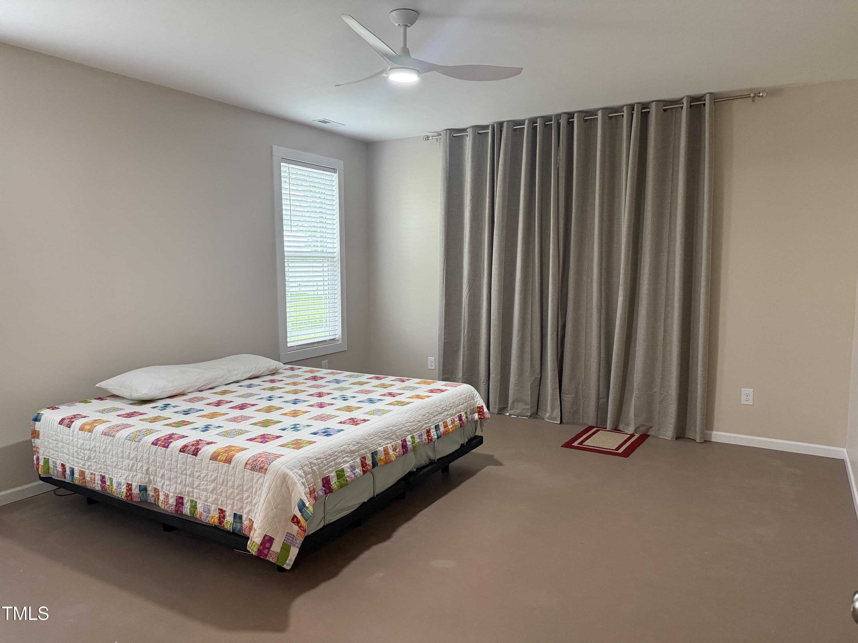 405 Sam Allen Road Roper, NC 27970 - Photo 19 of 32 a bed sitting in a bedroom next to a window