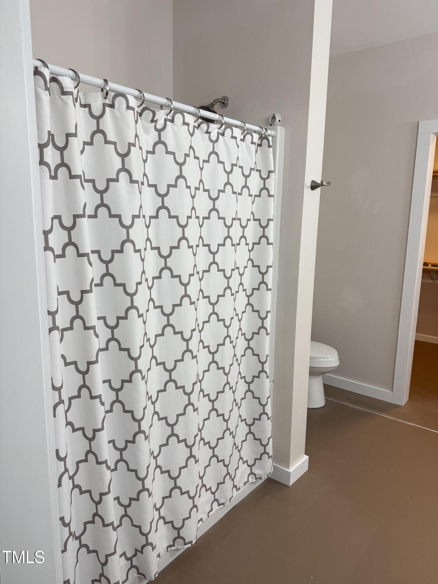 405 Sam Allen Road Roper, NC 27970 - Photo 22 of 32 a bathroom with a toilet and a shower curtain