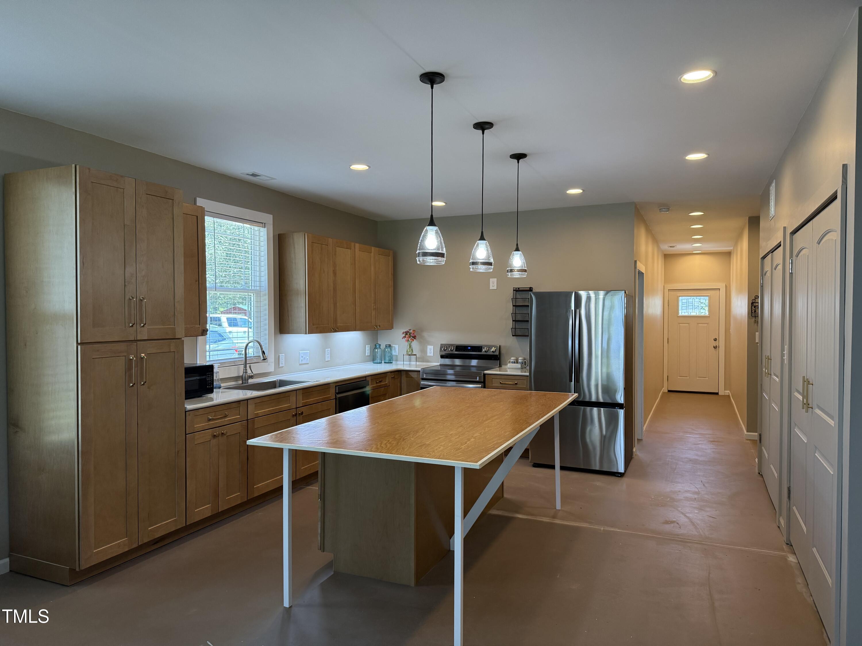 405 Sam Allen Road Roper, NC 27970 - Photo 8 of 32 a kitchen with stainless steel appliances granite countertop a refrigerator a sink and a stove
