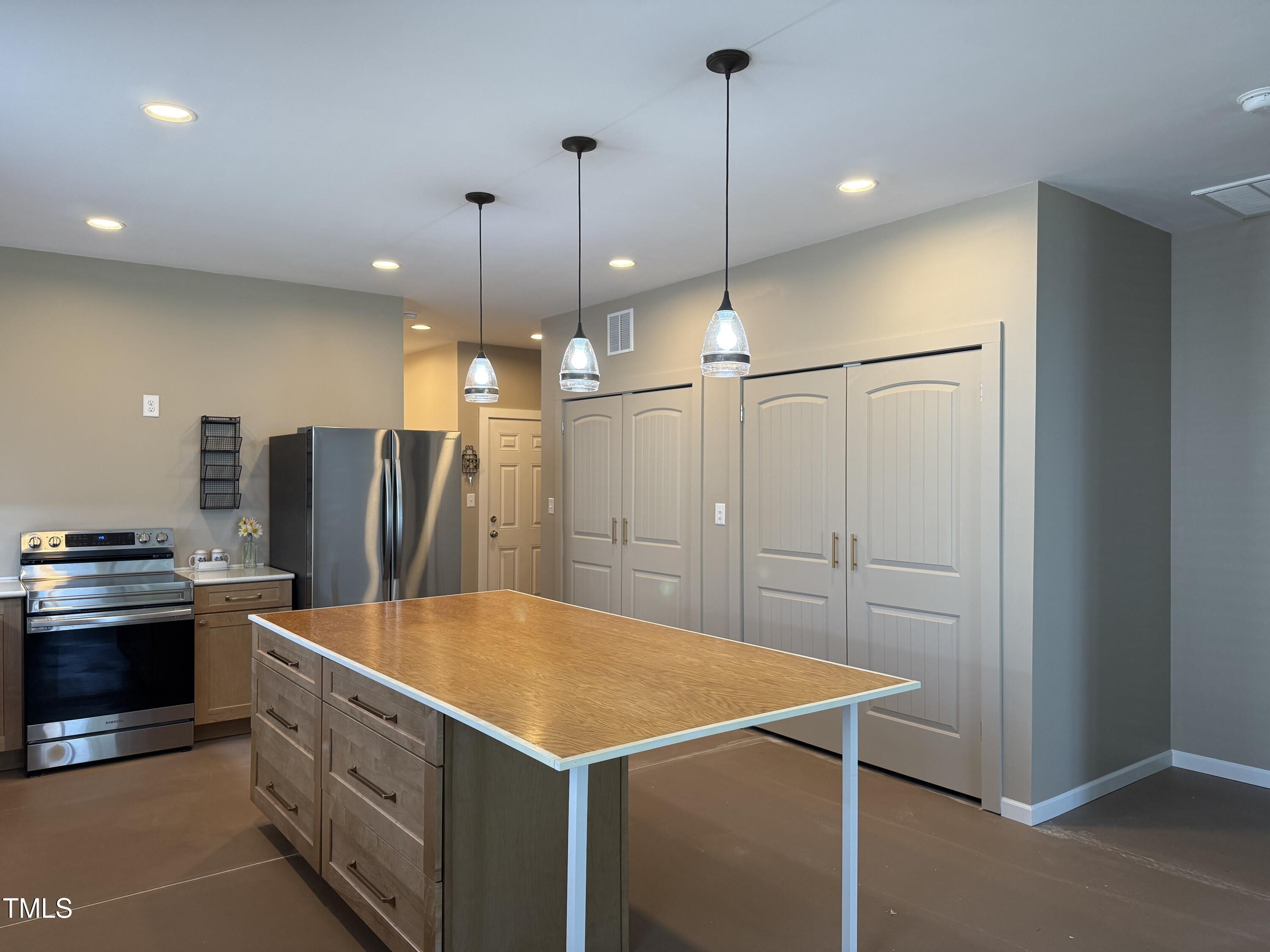 405 Sam Allen Road Roper, NC 27970 - Photo 9 of 32 a kitchen with stainless steel appliances kitchen island a refrigerator and a sink