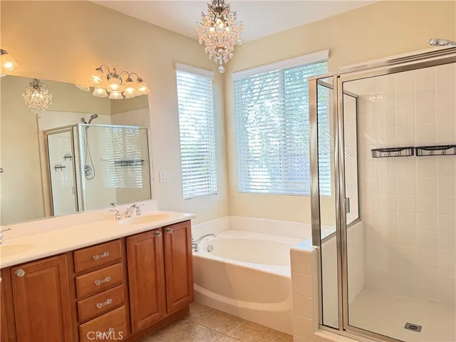 a bathroom with a tub shower and sink