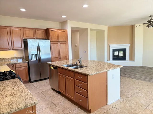 a kitchen with stainless steel appliances granite countertop a stove a refrigerator and a refrigerator