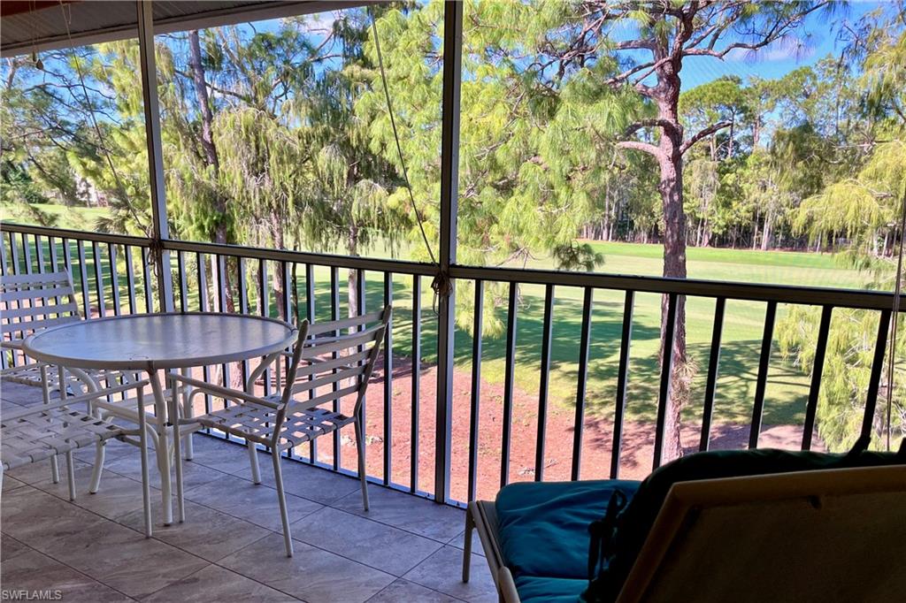 3685 Amberly Circle, Unit D305 Naples, FL 34112 - Photo 1 of 42 a view of a chairs and table in patio