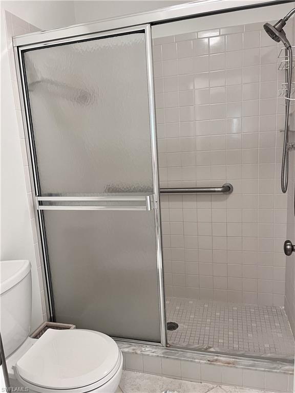 3685 Amberly Circle, Unit D305 Naples, FL 34112 - Photo 12 of 42 a white toilet sitting next to a shower