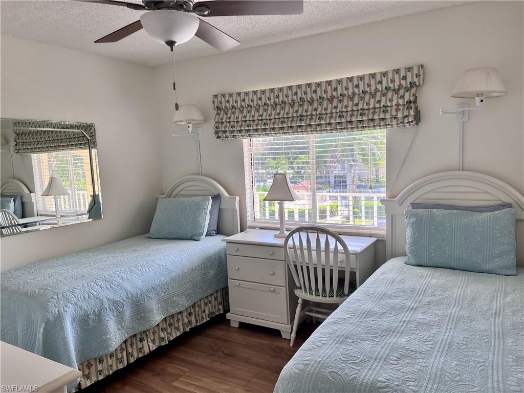 3685 Amberly Circle, Unit D305 Naples, FL 34112 - Photo 13 of 42 a bedroom with a bed and a window