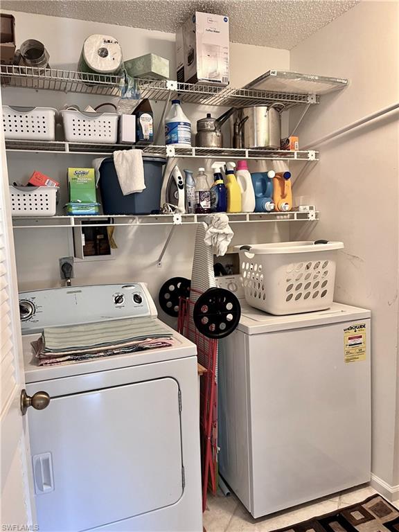 3685 Amberly Circle, Unit D305 Naples, FL 34112 - Photo 16 of 42 a utility room with dryer and washer