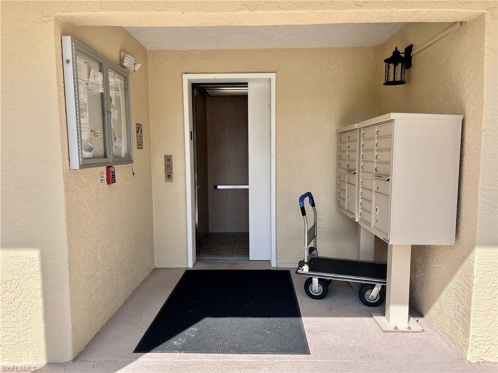 3685 Amberly Circle, Unit D305 Naples, FL 34112 - Photo 18 of 42 a view of entryway with livingroom and couch