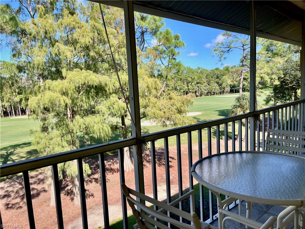 3685 Amberly Circle, Unit D305 Naples, FL 34112 - Photo 2 of 42 a view of a city from a balcony with furniture