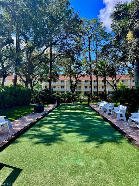 3685 Amberly Circle, Unit D305 Naples, FL 34112 - Photo 23 of 42 a view of a backyard with sitting area