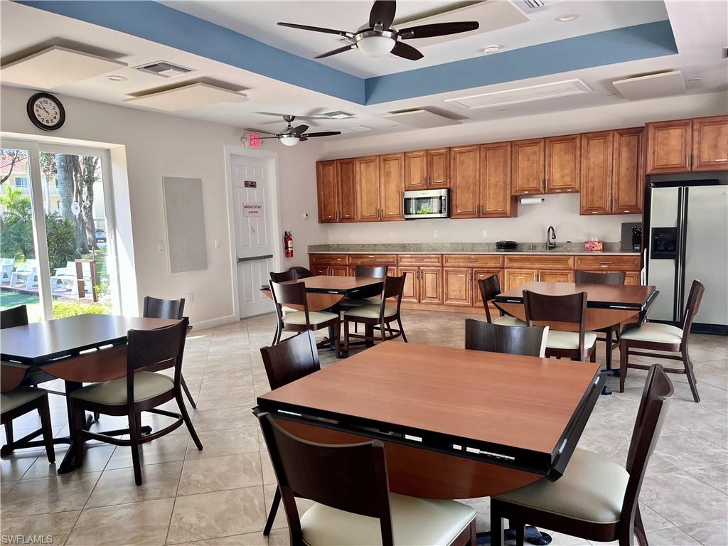 3685 Amberly Circle, Unit D305 Naples, FL 34112 - Photo 27 of 42 a view of a dining room with furniture window and outside view