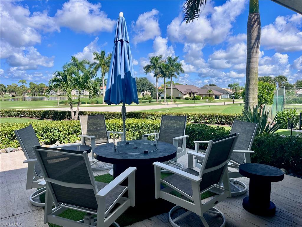 3685 Amberly Circle, Unit D305 Naples, FL 34112 - Photo 32 of 42 a view of an outdoor sitting area with furniture and garden