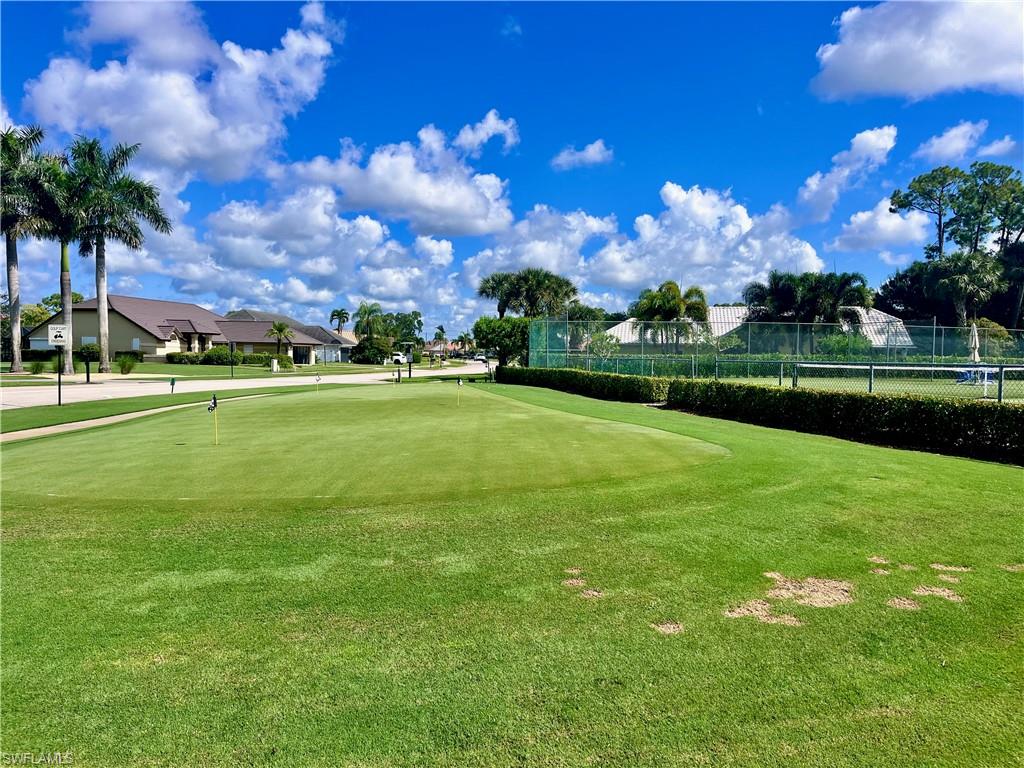 3685 Amberly Circle, Unit D305 Naples, FL 34112 - Photo 42 of 42 a view of a golf course with a lake
