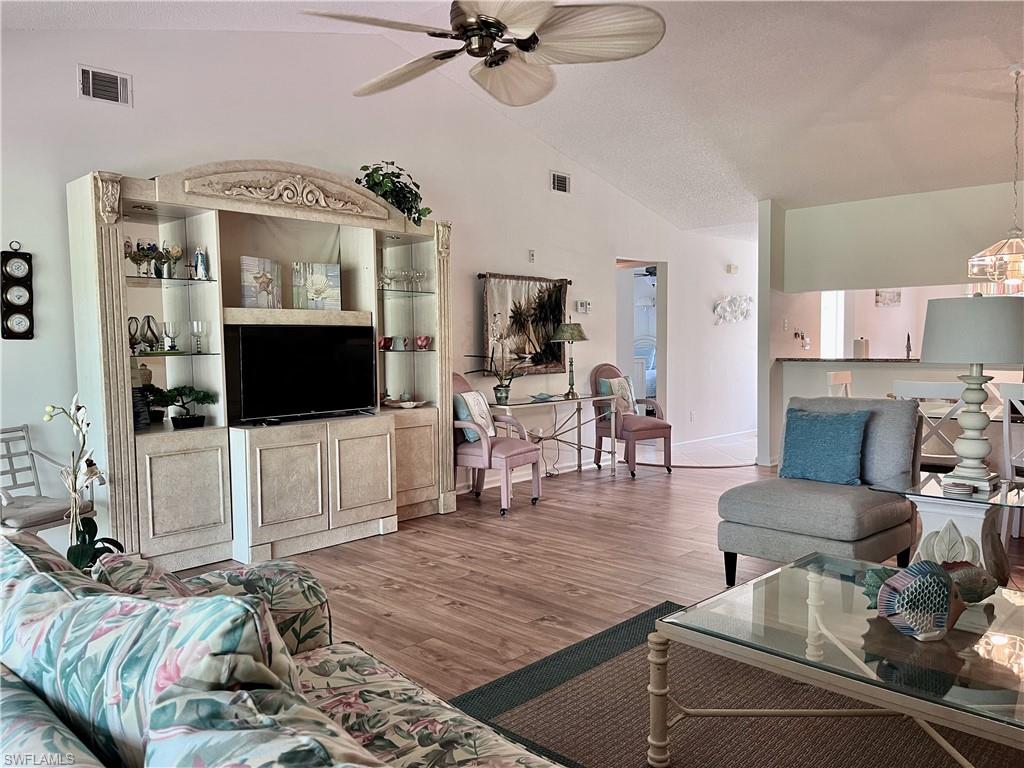 3685 Amberly Circle, Unit D305 Naples, FL 34112 - Photo 6 of 42 a living room with furniture and a flat screen tv