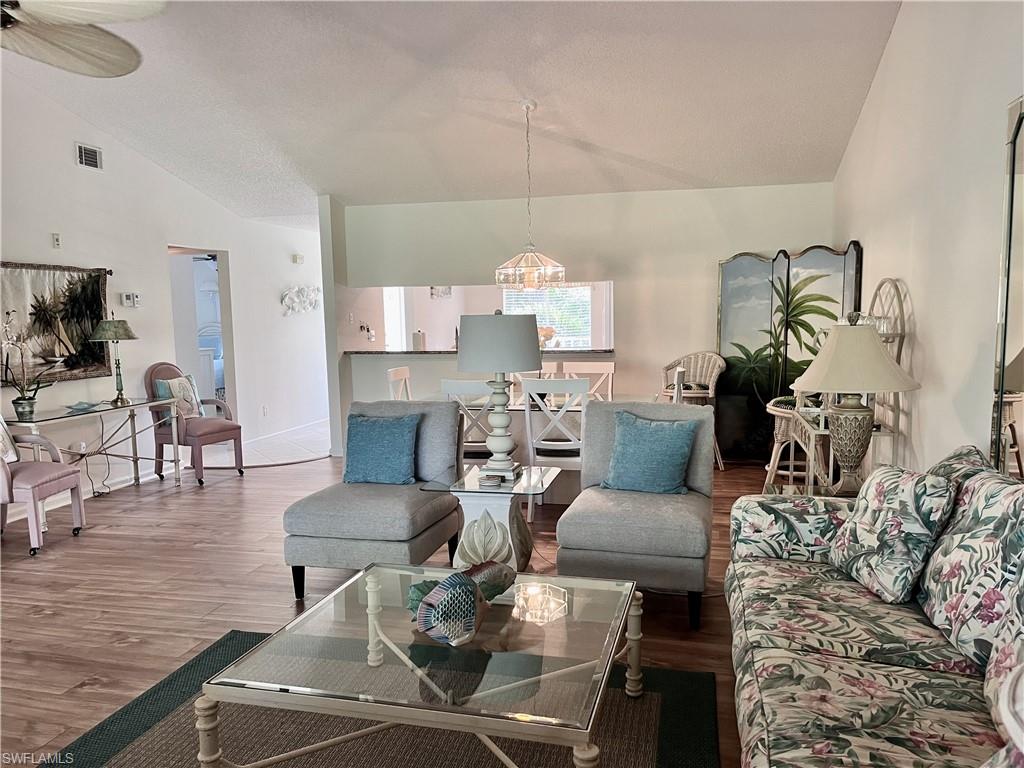 3685 Amberly Circle, Unit D305 Naples, FL 34112 - Photo 7 of 42 a living room with fireplace furniture and a rug