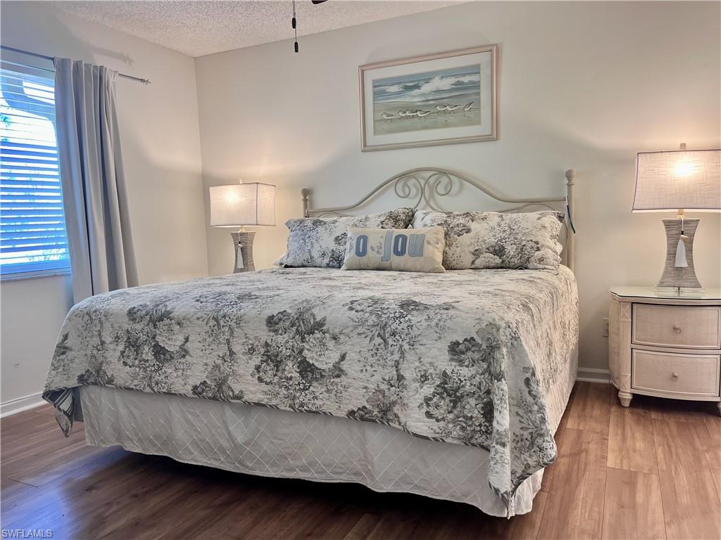 3685 Amberly Circle, Unit D305 Naples, FL 34112 - Photo 8 of 42 a bedroom with a bed and a dresser