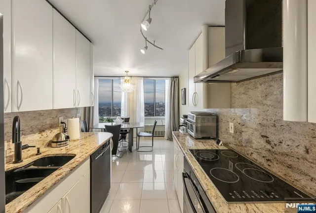 a kitchen with sink stove and cabinets
