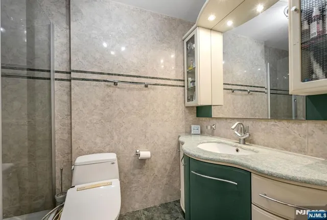 a bathroom with a sink toilet and shower
