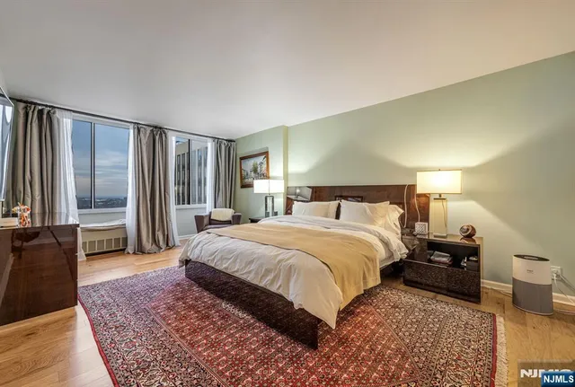 a bedroom with a large bed and a dresser