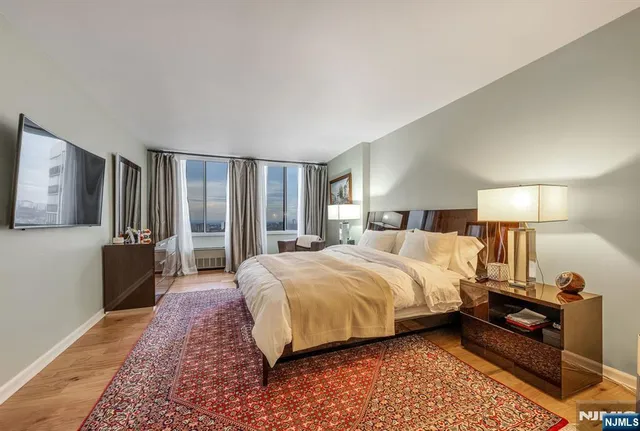 a spacious bedroom with a bed a couch and a dresser