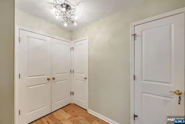 a view of a hallway with a chandelier fan