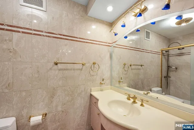 a bathroom with a sink a mirror and shower