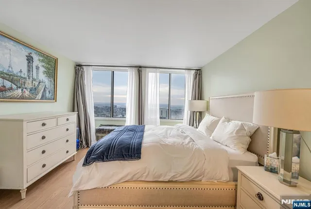 a bedroom with a large bed and a window