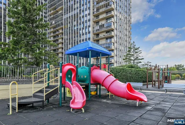 a view of a swimming pool with a lounge chairs and a small yard