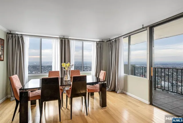 a view of a dining room with furniture large windows and wooden floor