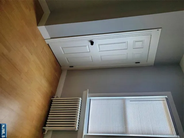 a view of an empty room with a kitchen