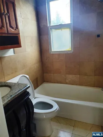 a utility room with lots of clutter and washer