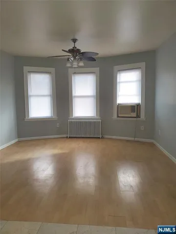 a view of kitchen with refrigerator and window