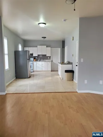a kitchen with a stove a refrigerator and cabinets