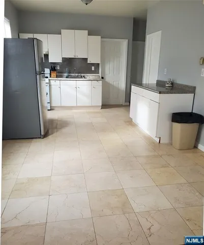 a kitchen with cabinets and white stainless steel appliances