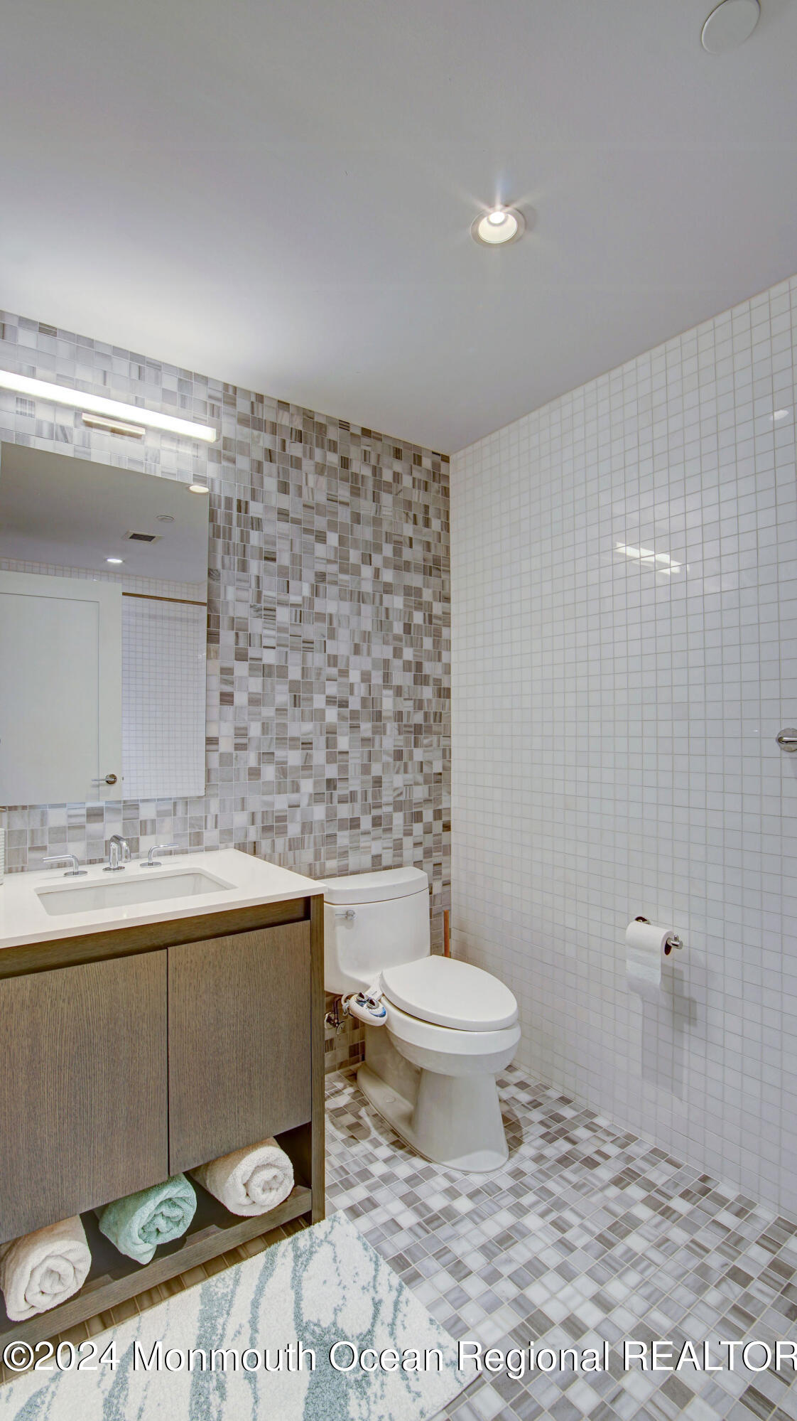 15 Morris Avenue, Unit 307 Long Branch, NJ 07740 - Photo 15 of 33 a bathroom with a toilet a sink and mirror