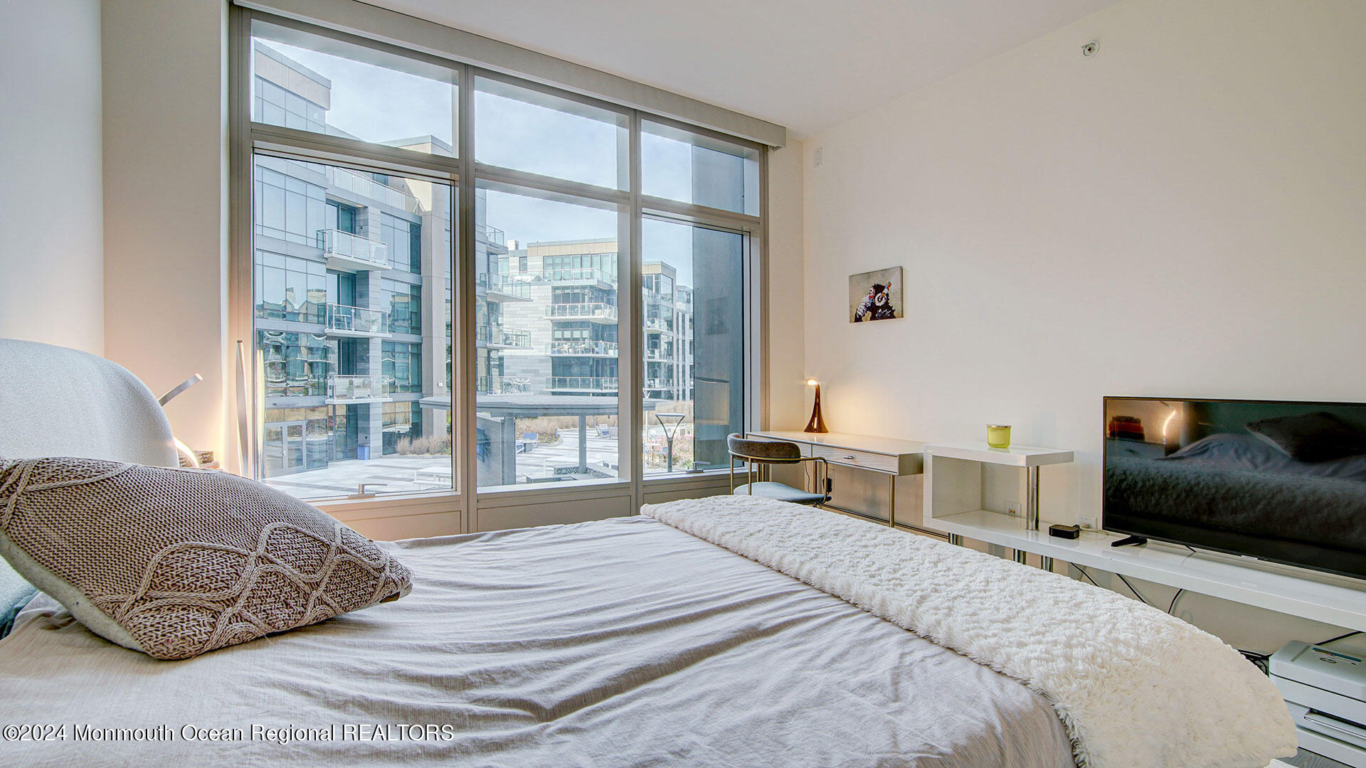 15 Morris Avenue, Unit 307 Long Branch, NJ 07740 - Photo 18 of 33 a bedroom with a large bed and a large window