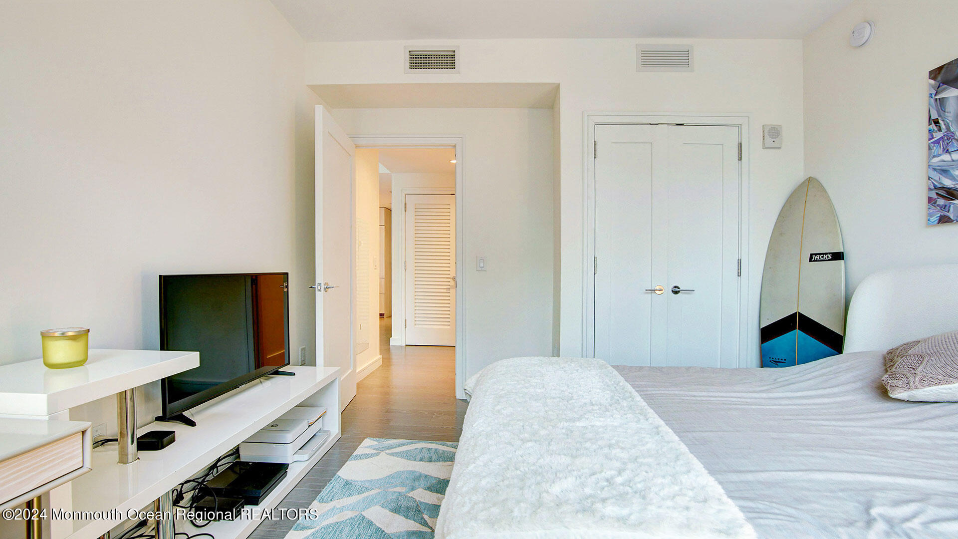 15 Morris Avenue, Unit 307 Long Branch, NJ 07740 - Photo 19 of 33 a bedroom with a bed and flat screen tv