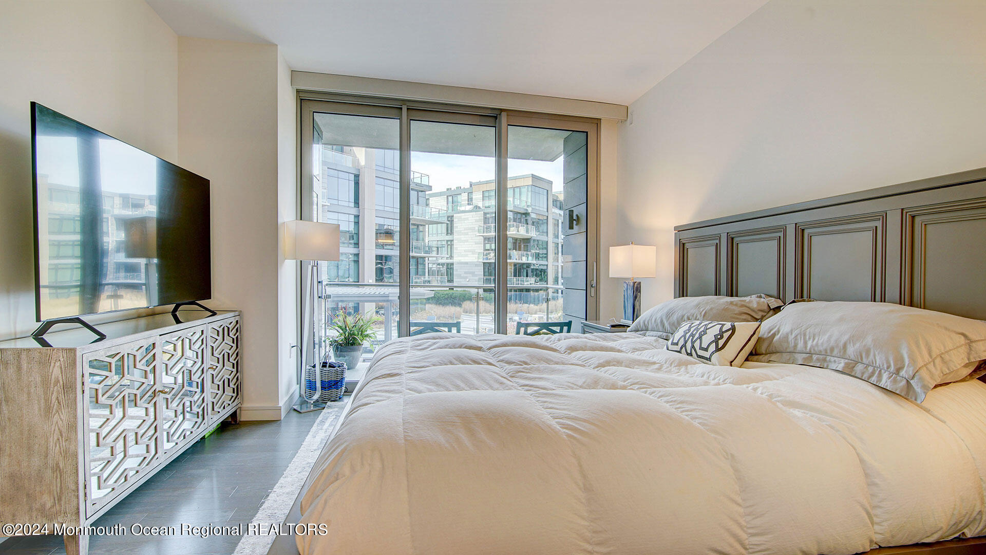 15 Morris Avenue, Unit 307 Long Branch, NJ 07740 - Photo 21 of 33 a bedroom with a bed and a large window