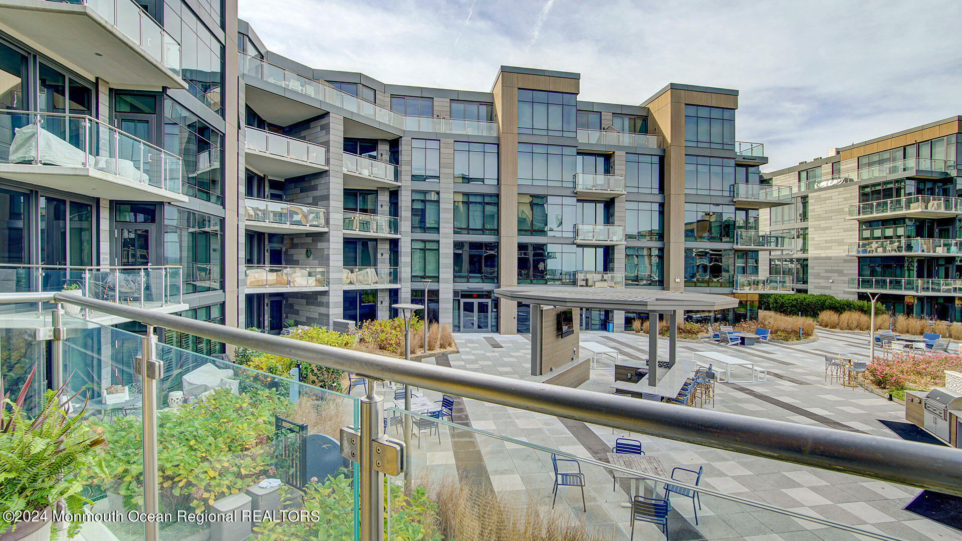 15 Morris Avenue, Unit 307 Long Branch, NJ 07740 - Photo 28 of 33 a balcony view with couple of cars parked in front of a building