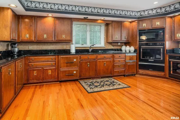 a spacious bedroom with a bed and a flat screen television