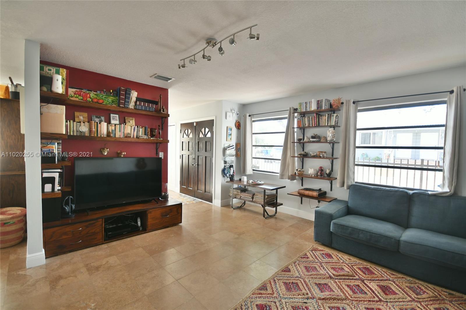 3141 Southwest 27th Terrace, Unit B Miami, FL 33133 - Photo 3 of 15 a living room with furniture and a flat screen tv