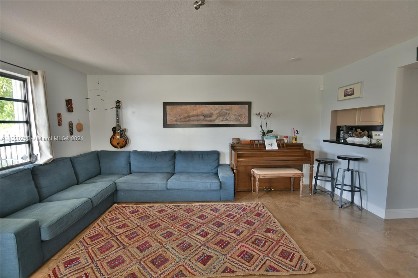 3141 Southwest 27th Terrace, Unit B Miami, FL 33133 - Photo 4 of 15 a living room with furniture a piano and a flat screen tv