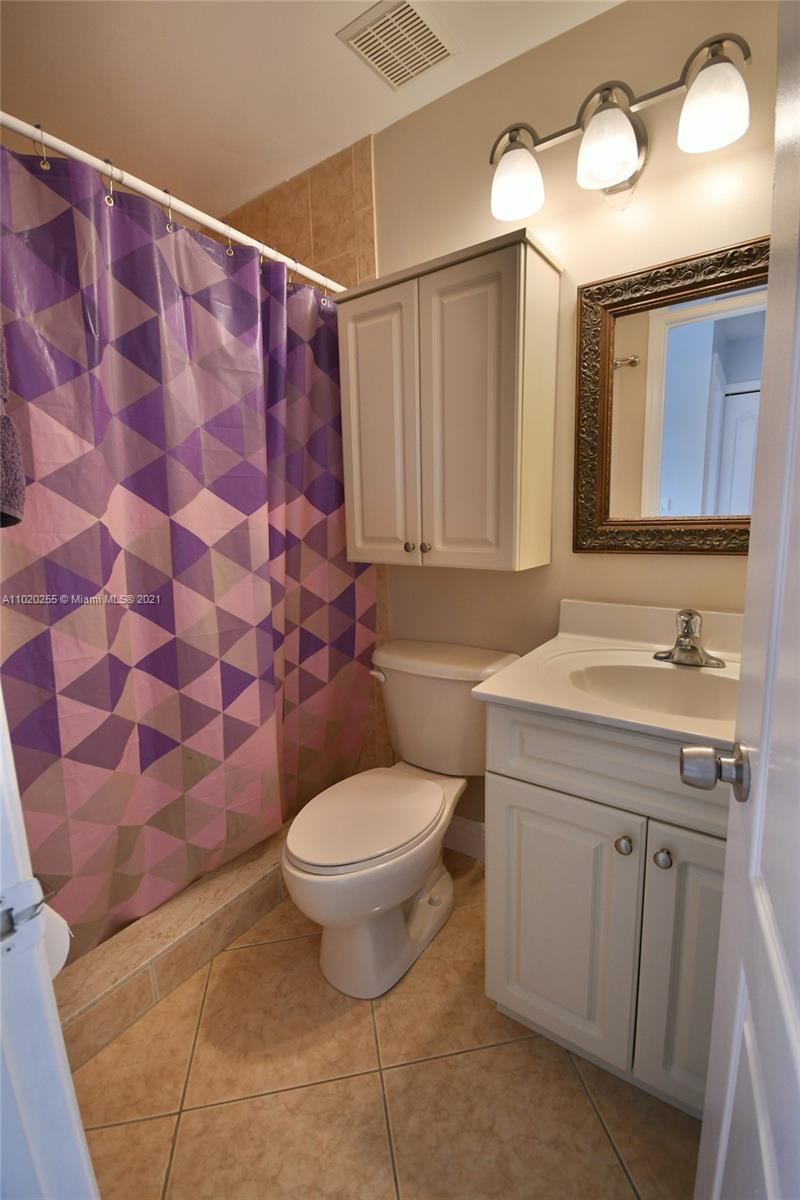 3141 Southwest 27th Terrace, Unit B Miami, FL 33133 - Photo 9 of 15 a bathroom with a granite countertop sink toilet and a mirror