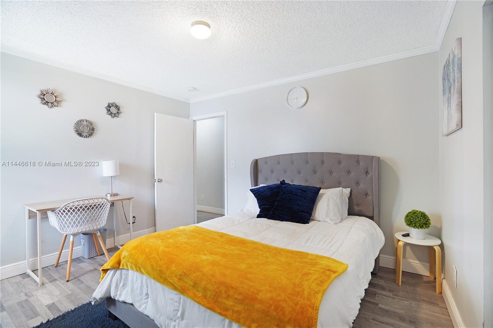 1330 Sesame Street Opa-Locka, FL 33054 - Photo 13 of 27 a bedroom with a bed and chair