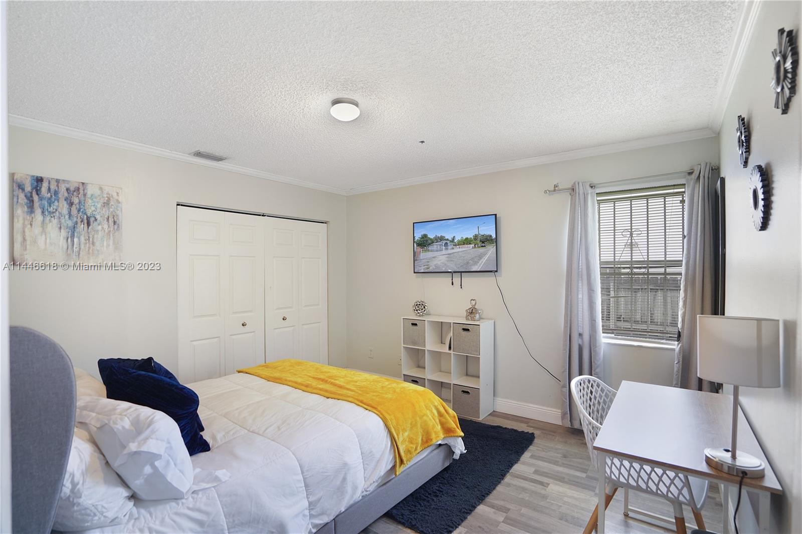 1330 Sesame Street Opa-Locka, FL 33054 - Photo 14 of 27 a bedroom with a bed and wooden floor