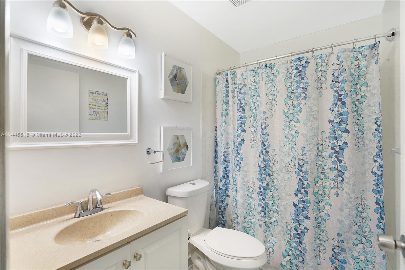 1330 Sesame Street Opa-Locka, FL 33054 - Photo 16 of 27 a bathroom with a sink a toilet and a mirror